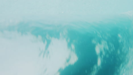 Detailed-closeup-of-ocean-barrel-rearview-from-underwater
