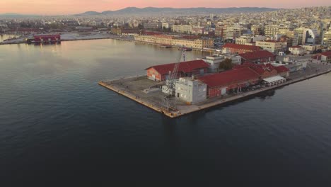 Sunrise-Thessaloniki-Waterfront:-Aerial-Drone-Captures-First-Light-at-the-Iconic-Pier,-Illuminating-the-Serene-Aegean-Sea-–-Vibrant-Morning-Colors-Paint-Greece's-Coastal-Cityscape-Θεσσαλονίκη,-Ελλάδ?