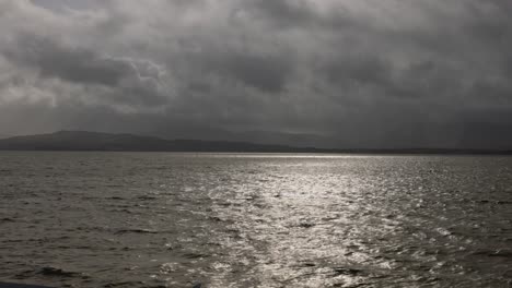 Hand-held-shot-of-moody-clouds-with-sun-shining-through-at-the-scottish-coast