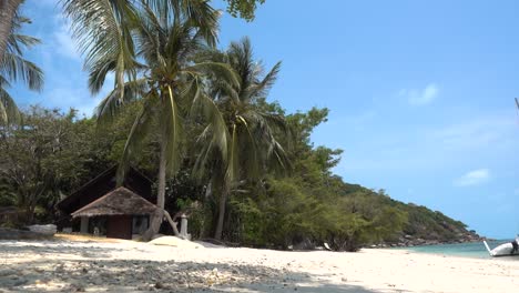 Beautiful-scenery-on-tropical-beach-with-small-bungalow-in-tropical-setting