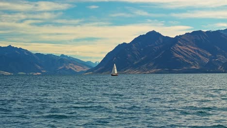 Sailboat-floats-peacefully-on-calm-serene-waters-of-Lake-Hawea