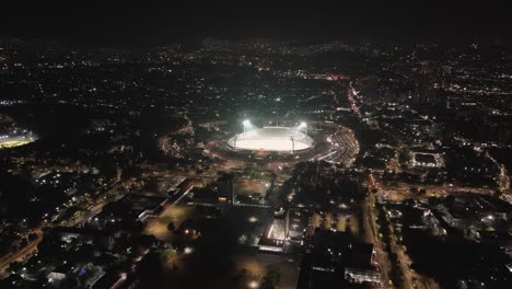 Check-out-the-UNAM's-Olympic-Stadium-from-above,-all-lit-up-at-night-in-Mexico-City
