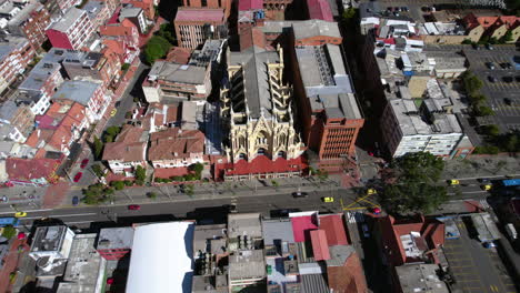 Parish-of-Our-Lady-of-Chiquinquira-Church-in-Chapinero,-Bogota,-Colombia,-Aerial-View-of-Landmark-and-Traffic-on-Caracas-Avenue