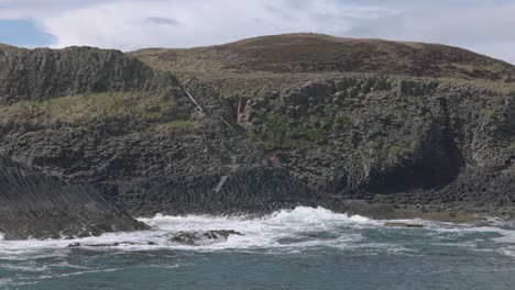 Handaufnahme-Von-Wellen,-Die-Gegen-Basaltfelsen-Auf-Der-Insel-Staffa-Krachen