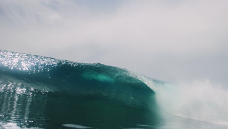 Ocean-wave-barreling-glistens-with-beautiful-clarity-as-vortex-forms-behind