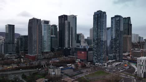 drone-approaching-Montreal-modern-skyline-cityscape-urban-building-Quebec-Canada-smart-city-aerial-footage