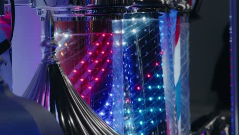 Multicolored-LED-lights-cascade-down-transparent-tubes,-creating-a-vibrant-display