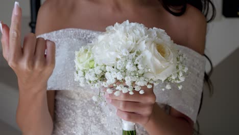Slow-motion-shot-of-a-bride-in-a-beautiful-white-dress-holding-a-white-bouquet