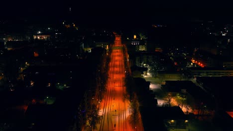 Aerial-view-backwards-over-the-quiet-streets-of-Kuopio,-winter-evening-in-Finland