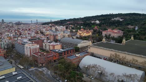 Barcelona-skyline-with-colorful-buildings-at-dusk,-showing-urban-density,-aerial-view