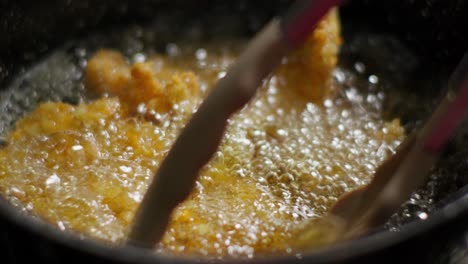 Frying-breaded-chicken-fillets-in-oil-in-a-frying-pan