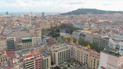 Barcelona-skyline-with-a-mix-of-modern-and-historic-architecture-during-the-day,-aerial-view