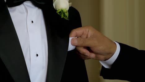 Slow-motion-shot-of-a-best-man-adjusting-a-pocket-square-on-the-groom