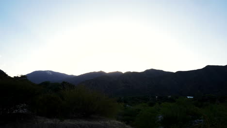 Time-lapse-of-the-Andes-mountain-range-from-dusk-until-nightfall,-capturing-the-sunset-and-the-sun-setting-behind-the-mountains