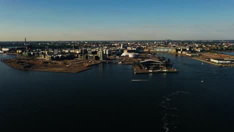 Aerial-tracking-shot-of-the-west-waterfront-of-Helsinki,-golden-hour-in-Finland