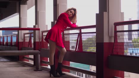 A-short-red-dress-adorns-a-young-Hispanic-girl-as-she-navigates-the-city's-parking-garage