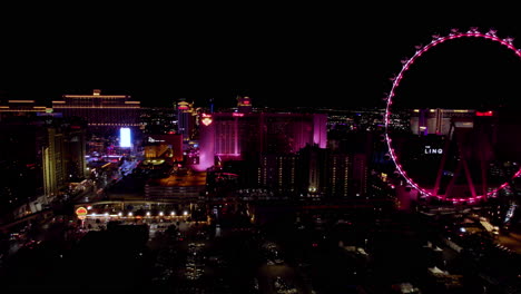 Las-Vegas-USA,-Aerial-View-of-Shiny-Strip-Buildings-and-Night,-High-Roller-Ferris-Wheel,-The-Linq,-Flamingo,-Bellagio