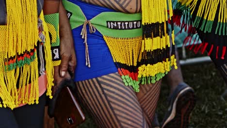 Indigenous-amazonian-people-in-traditional-dresses-holding-hands-dancing