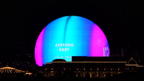Las-Vegas-USA,-Sphere-Experience-at-Night-With-Advert-Animation-For-U2-Achtung-Baby-Concerts