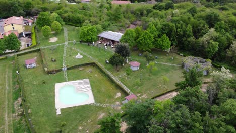 Scenic-Aerial-View-of-Modern-building-and-Huge-Garden-at-a-Wedding-Celebration-in-Parco-Regionale-dei-Colli-Euganei