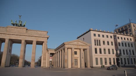In-the-golden-morning-sunlight,-in-front-of-the-Brandenburg-Gate,-there-is-a-tourist-taking-photos