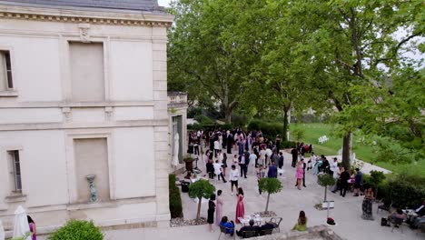 Wedding-Guests-outside-big-architectural-building-for-the-wedding-party