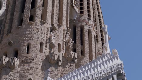 Sunlight-bathes-the-intricate-facade-of-Sagrada-Familia,-showcasing-its-architectural-glory,-clear-sky