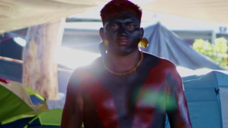 An-indigenous-amazon-man-with-painted-tace-and-body-is-protesting-at-the-cop-30-march