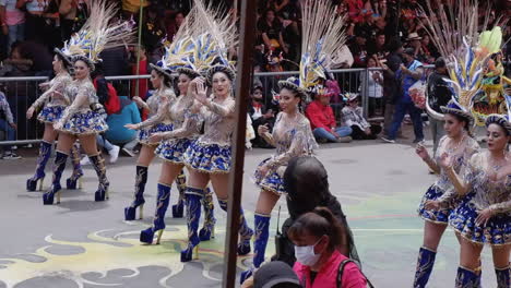 Women-in-fancy-mini-skirts,-high-heel-boots-in-Oruro-Carnival-parade