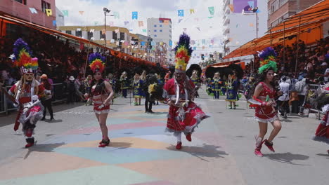 Dancers-in-fringe-dress,-feather-headdress-in-parade,-Oruro-Carnival