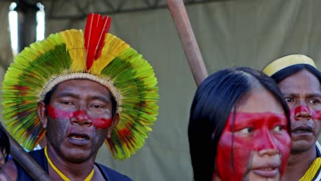 An-indigenous-amazon-man-and-woman-with-colorful-painted-faces-are-dancing