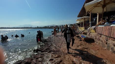 Scuba-Divers-In-Dahab-Resort-Town-During-Summer-On-Southeast-Coast-Of-Sinai-Peninsula-In-Egypt