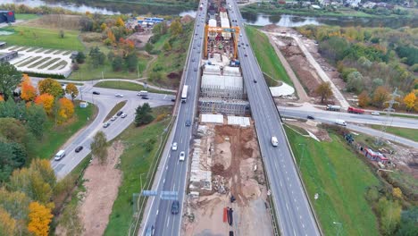 Construction-site-of-A1-bridge-over-Neris-river-in-Kaunas,-aerial-view
