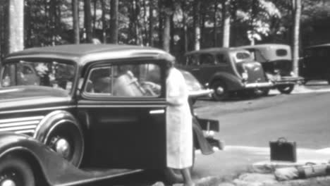 Woman-Gets-into-a-Classic-Car-Outside-a-Golf-Club-on-a-Summers-Day-of-1930s