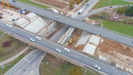 Vehicles-passing-by-construction-site-of-A1-highway-bridge-in-Kaunas,-aerial-view