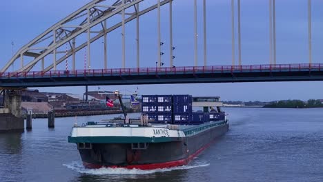 Das-Schiff-Xanthos-Fährt-Bei-Sonnenuntergang-Unter-Der-Brücke-In-Alblasserdam,-Niederlande,-Durch---Drohnenaufnahme