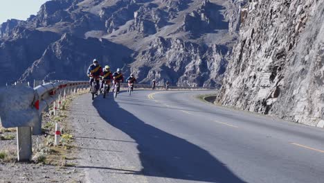 Bicycle-tourists-ride-bikes-on-mountain-highway-near-La-Paz-in-Bolivia