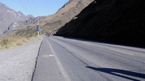 Group-of-mountain-bikers-ride-bicycles-on-Bolivian-highway-near-La-Paz