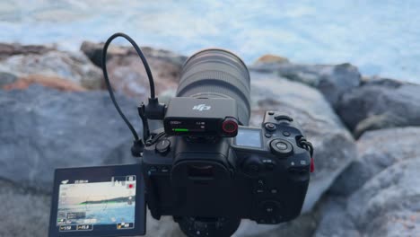 DJI-Micr-2-attached-to-recording-professional-camera-on-sea-rocks