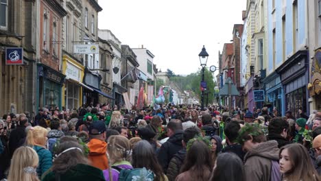 Streets-packed-with-people-during-Beltane-May-Day-festivities-and-celebrations-in-Glastonbury-town,-Somerset-UK