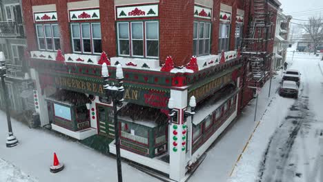 Christmas-gingerbread-store-in-American-town-during-snow-storm-at-holiday-time