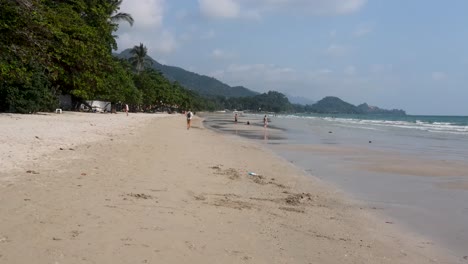 Low-Flying-Along-White-Sand-Beach-At-Koh-Chang-With-Tourists-Enjoying-The-Day