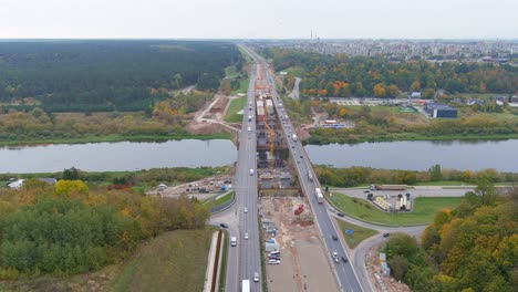 Main-highway-road-of-Lithuania-with-bridge-over-Neris-river,-aerial-view