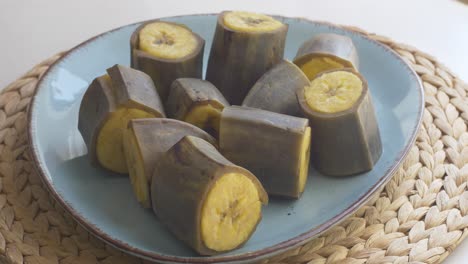 Peeling-steaming-hot-boiled-plantain-bananas,-part-3