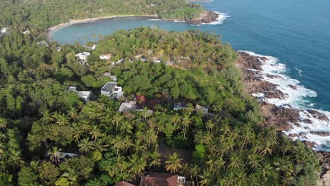 Aerial-Drone-View-Along-Lush-Coast-of-Hiriketiya-Beach,-Dikwella,-Sri-Lanka