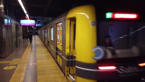 Underground-Station-of-Line-A,-train-departing,-pedestrians-walk,-establishing-of-Carabobo-subway,-Buenos-Aires-City,-Argentina-public-transportation