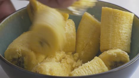 Mashing-banana-plantain-with-a-fork-to-make-a-puree,-part-1