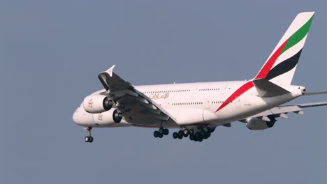 Descending-and-deploying-its-landing-gears-as-it-prepares-to-land-at-the-tarmac-of-Suvharmabhumi-airport-in-Bangkok,-Thailand