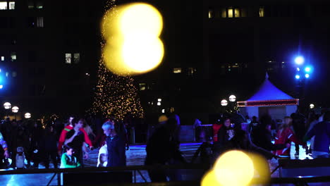 Los-Angeles-CA-USA,-Christmas-Time,-People-on-Ice-Skating-at-Ice-Rink-on-Pershing-Square,-Crowd-and-Christmas-Lights