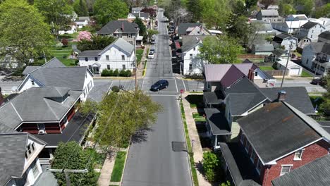 Cars-on-junction-in-small-historic-town-of-America-during-sunny-day